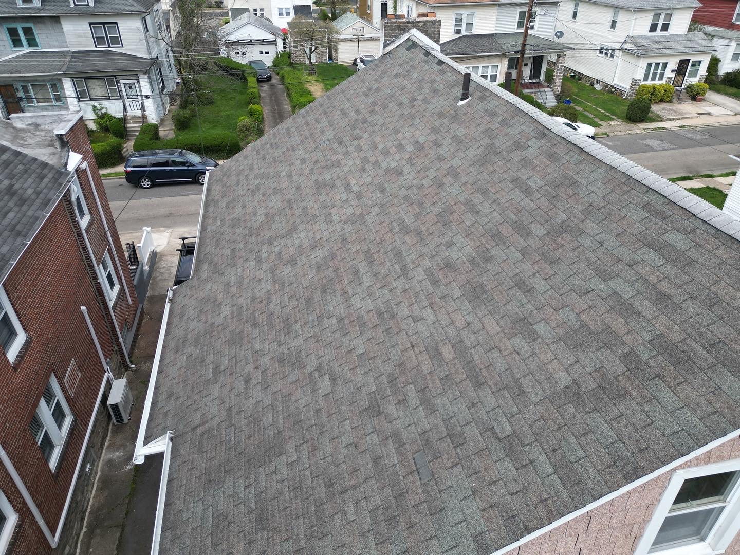 A completed asphalt shingle roof on a Delaware County home, photographed by drone